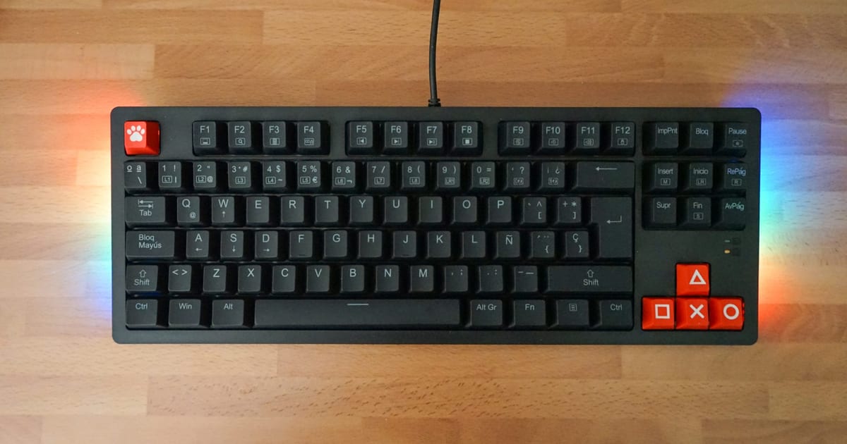 A compact mechanical keyboard on a wooden desk