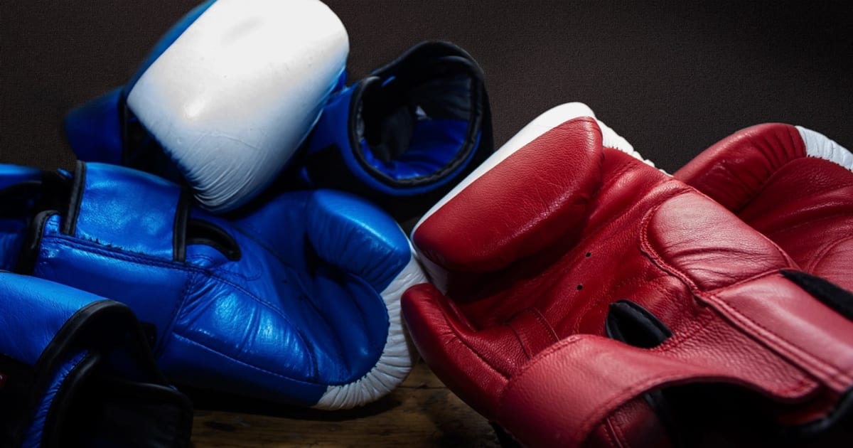Red and blue boxing gloves lying together